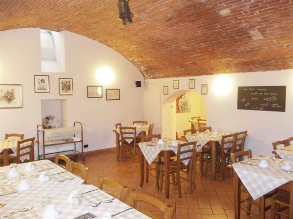 Dining room with set tables, brick vaulted ceiling and wooden chairs