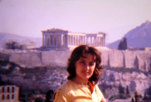 Smiling young woman in front of the Parthenon on the Athens Acropolis