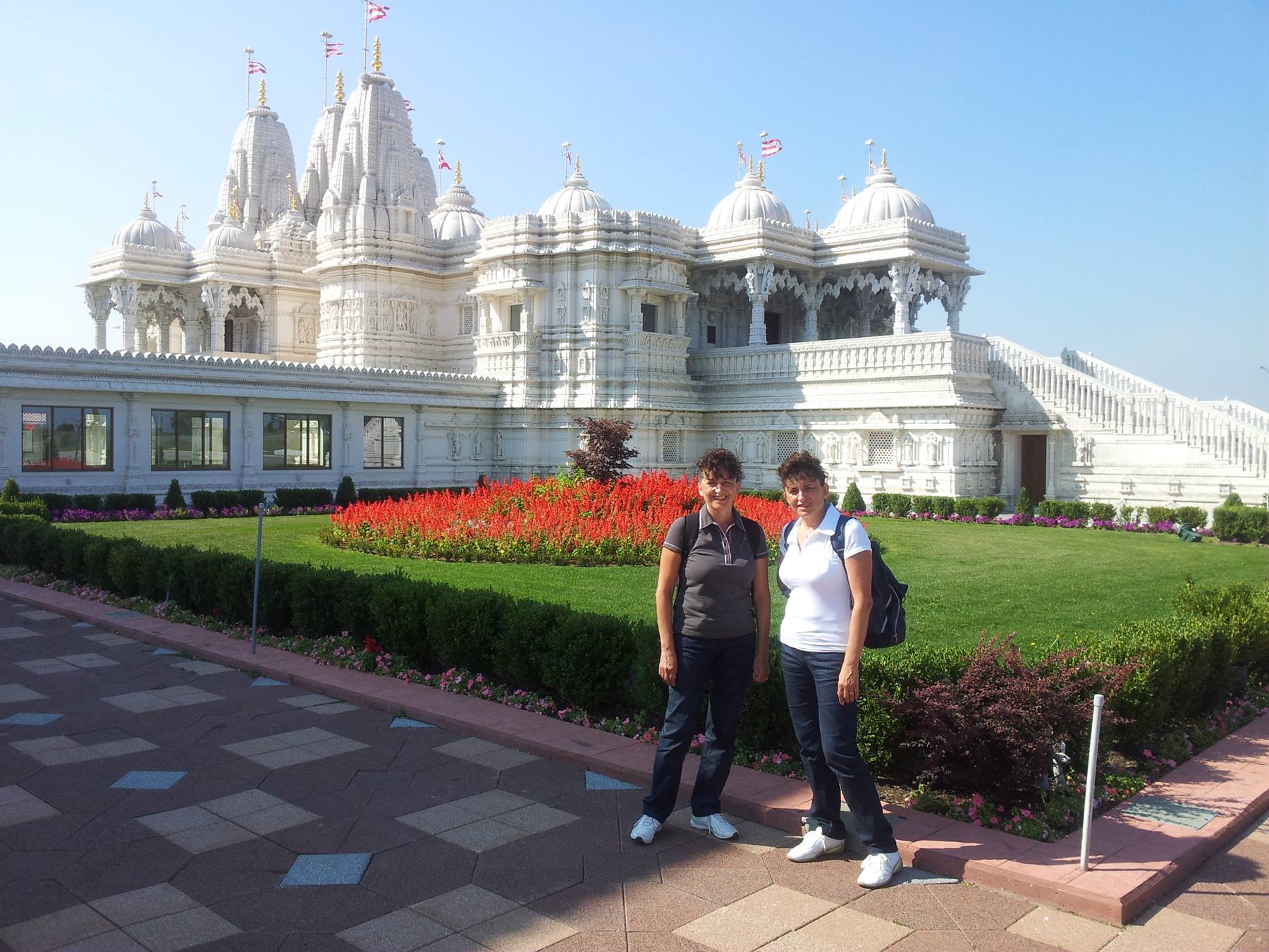 Two tourists in front of the white marble BAPS temple in Atlanta