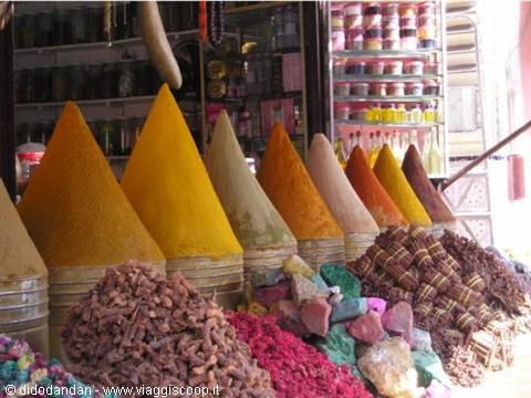 Colorful spice cones and soap stacks at Marrakech souk