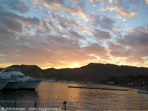 Yachts moored at Sharm el-Sheikh harbor under colorful clouds