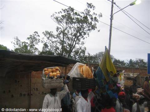 Women carrying bread baskets on their heads at the market