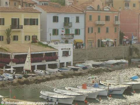 Boats moored at Marciana Marina harbor, colorful houses on Elba island