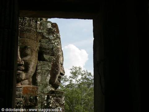 Carved stone faces framed through a doorway at Bayon, Angkor Thom