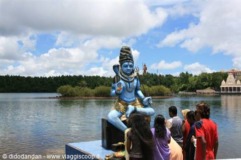 Tourists before the blue seated Shiva statue by the lake at Grand Bassin