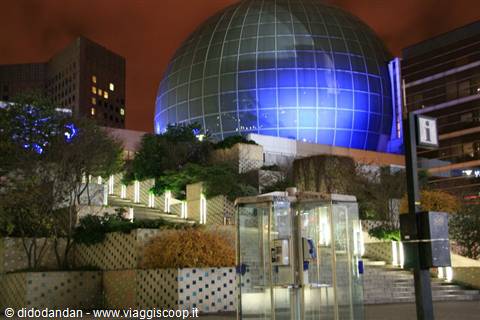 The Géode at night in Parc de la Villette, blue mirrored dome among trees