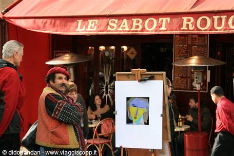 Painter with canvas outside Le Sabot Rouge café, Place du Tertre, Paris