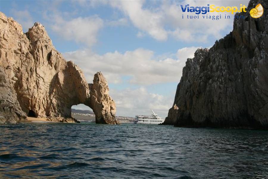 El Arco de Cabo San Lucas, limestone rock arch, white ship passing beyond