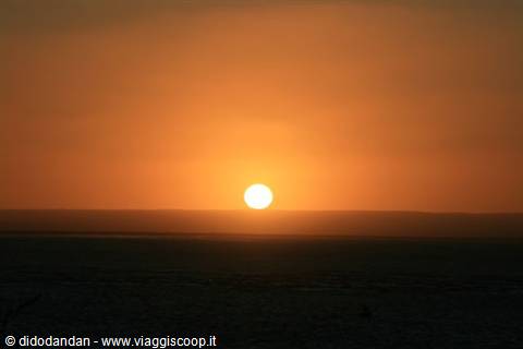 Sun sinking into the orange ocean at Cabo San Lucas