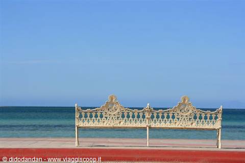 White wrought iron bench on La Paz waterfront facing the calm sea