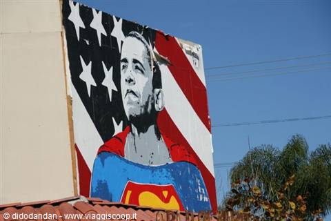 Mural of Obama dressed as Superman on American flag, blue sky