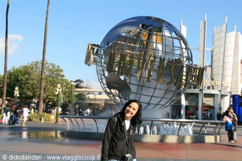 Smiling woman next to the metallic Universal Studios globe