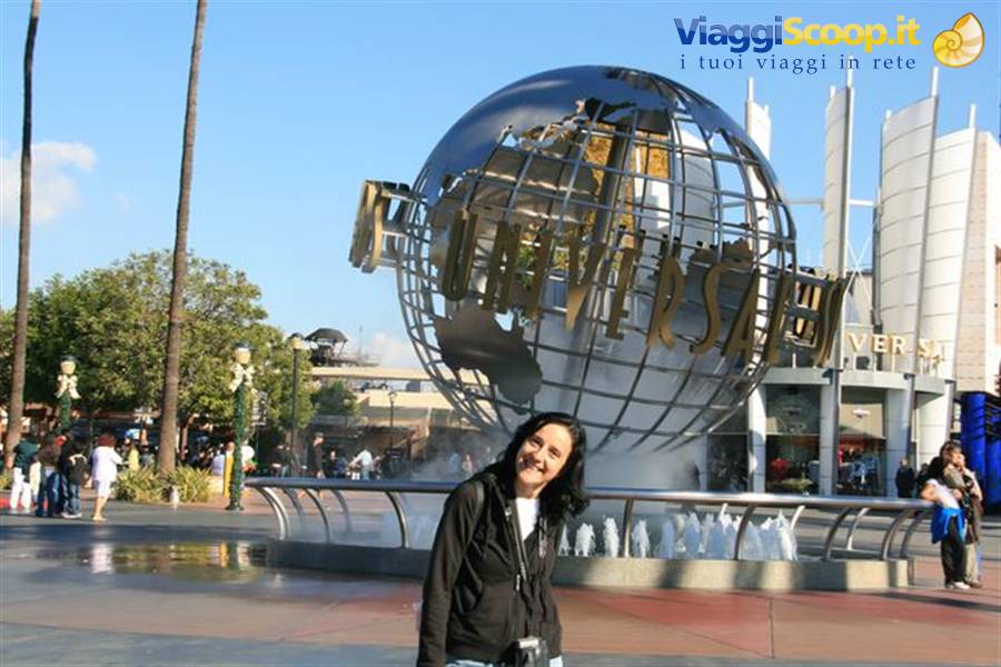 Smiling woman next to the metallic Universal Studios globe