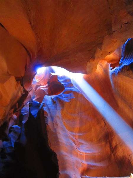 Light beam falling on sculpted sandstone walls of Antelope Canyon