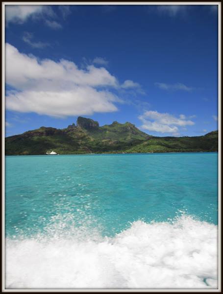 Boat wake on Bora Bora's turquoise lagoon beneath Mount Otemanu