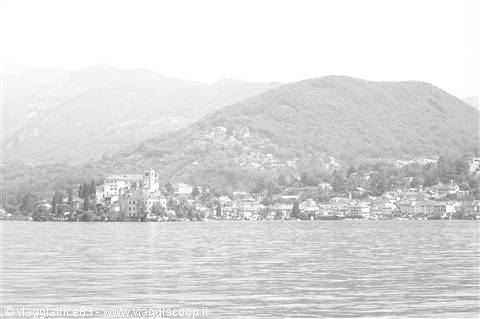 Isola San Giulio on Lake Orta, houses and bell tower amid hazy hills