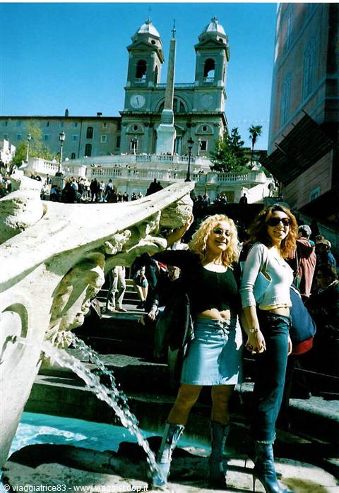 Two smiling women beside the Barcaccia fountain, Spanish Steps, Rome