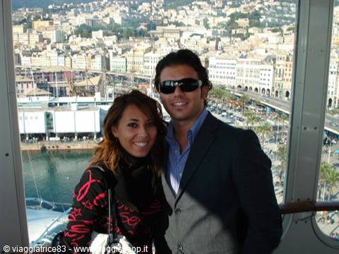 Smiling couple on the ferry, Naples harbor and buildings behind them