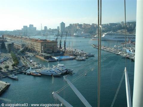Genoa old harbor with boats, brick warehouses and cruise ships