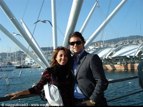 Smiling couple near the Bigo, Genoa's Porto Antico harbor