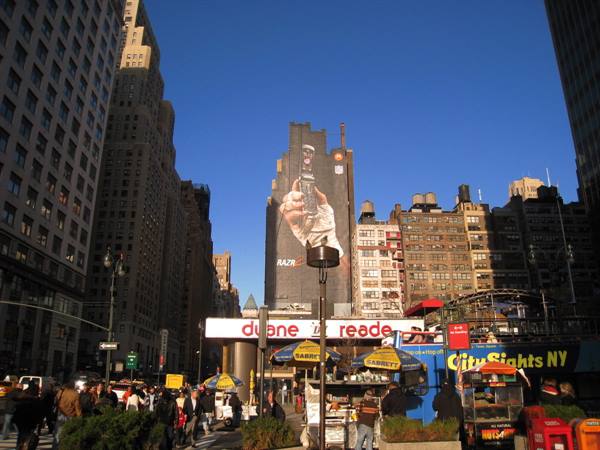 Food carts near Duane Reade and sunny skyscrapers, crowd in Manhattan