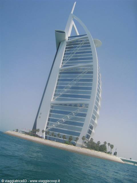 Burj Al Arab in Dubai, glass facade over blue sea and clear sky