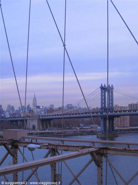 Brooklyn Bridge cables in front of Manhattan Bridge and Empire State Building