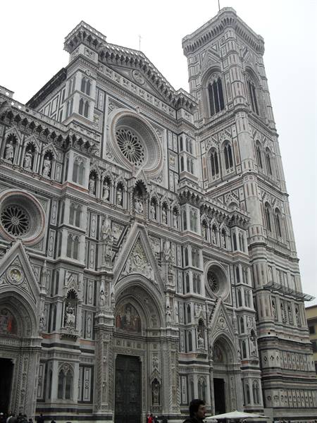 Marble facade of Florence Cathedral with Giotto's bell tower under grey sky