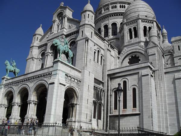 Sacré-Cœur basilica in Montmartre, white travertine facade with bronze equestrian statues