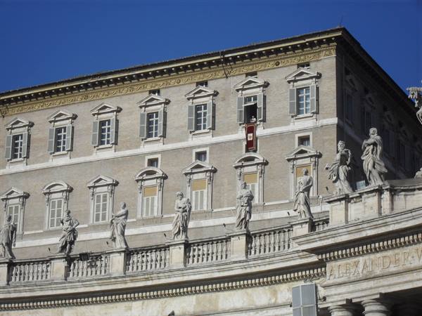 Apostolic Palace in Vatican with red papal curtain at window