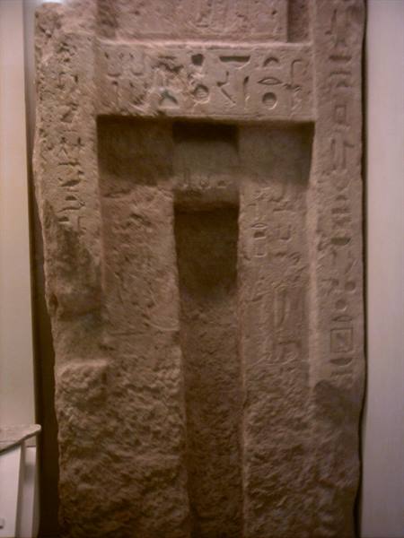 Stone stele carved with hieroglyphs, Egyptian false door in museum