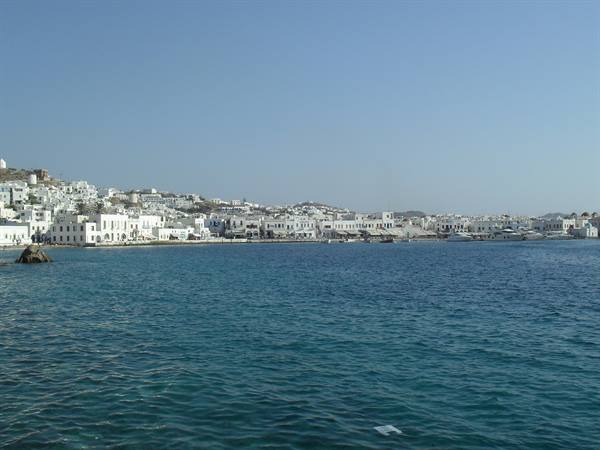Mykonos harbor with white houses overlooking the blue sea