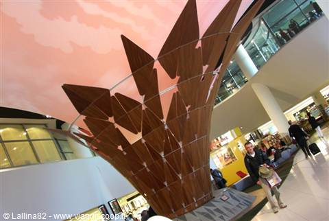 Wooden cone-shaped structure under painted ceiling at Heathrow Terminal 3, London