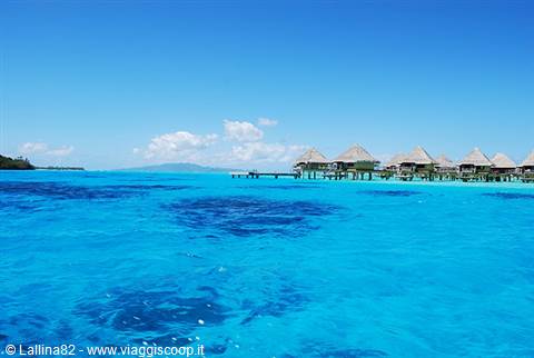 Overwater bungalows above Bora Bora's turquoise lagoon