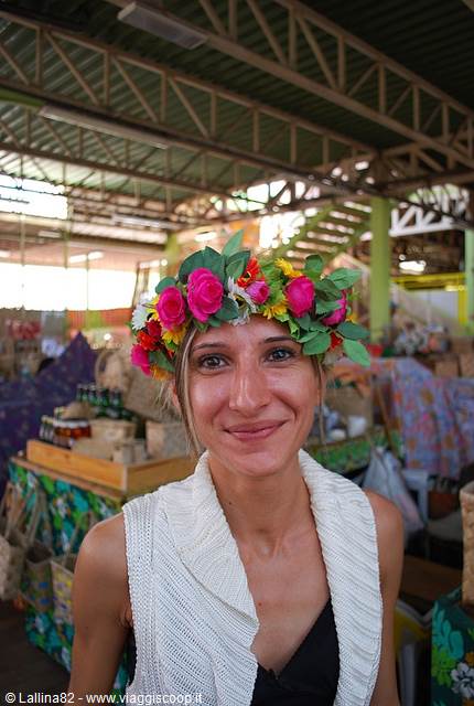 Smiling woman wearing an artificial flower crown at the covered market