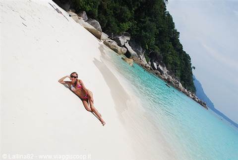 Woman in bikini lying on white sand, turquoise water and granite rocks, Similan Islands