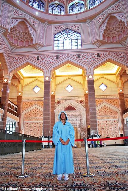 Woman in blue robe under the dome of Putra Mosque
