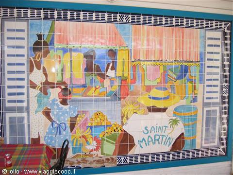 Colorful tile mural depicting a market scene with Saint Martin sign