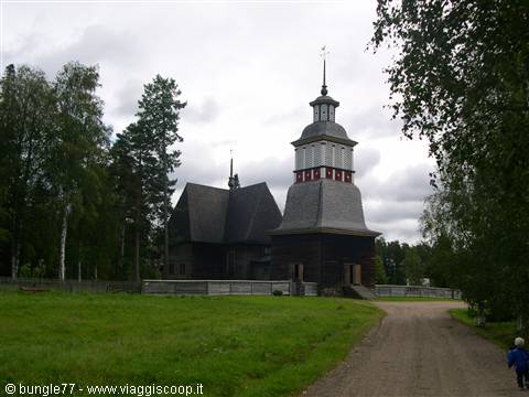 Petäjävesi wooden church, dark timber bell tower under a cloudy sky