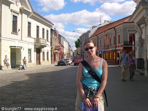 Girl wearing sunglasses on a cobbled street in Kaunas