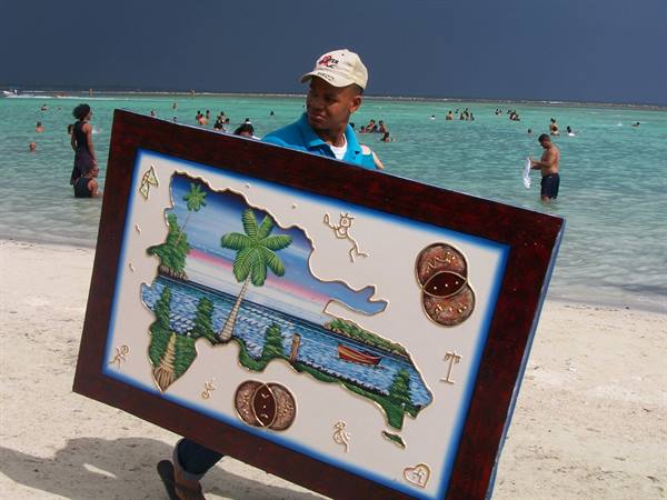 A seller of typical paintings on the beach in Boca Chica