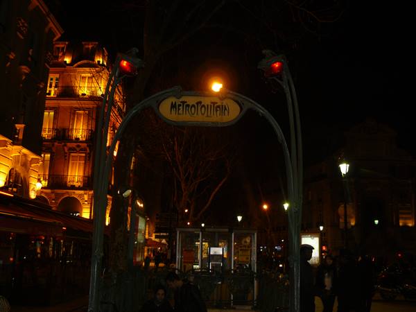 Art Nouveau Paris Metropolitain entrance sign glowing at night
