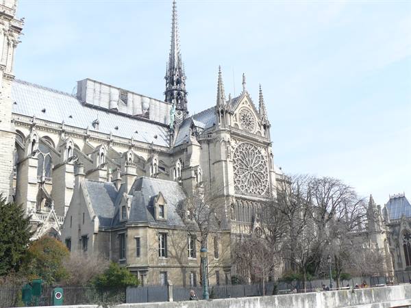 Notre-Dame Cathedral in Paris, Gothic stone facade with rose window, daylight
