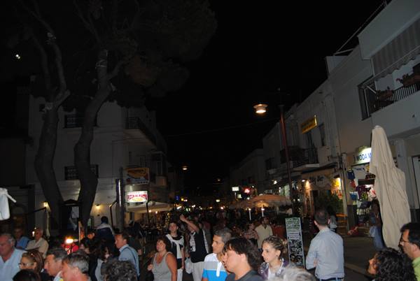 Crowd of tourists walking the lit street of Porto Cervo at night
