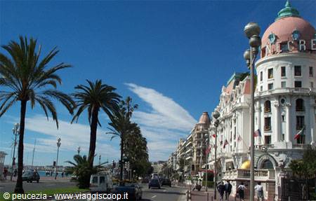 Palms and traffic on the Promenade des Anglais in front of the Negresco, Nice