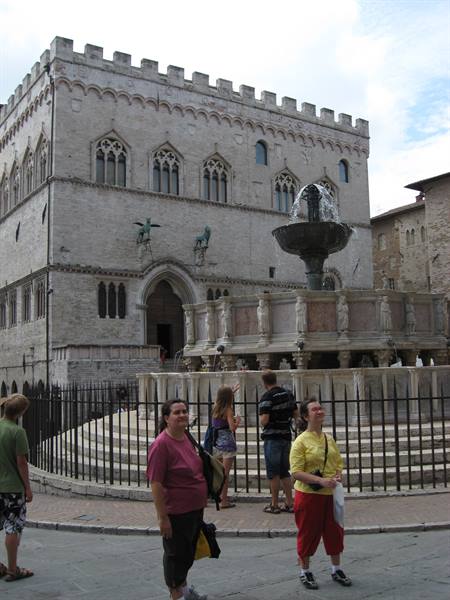Tourists beside the Fontana Maggiore and Priori Palace in Perugia