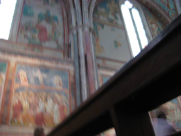 Medieval frescoes and painted vaults inside a church, blurred photo