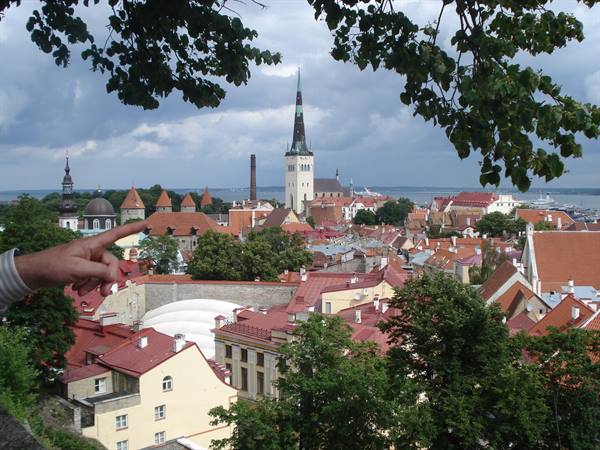 Tallinn: red rooftops and St. Olaf's spire under a cloudy sky