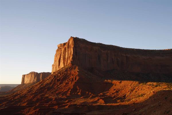 Red sandstone cliff of Monument Valley in morning light