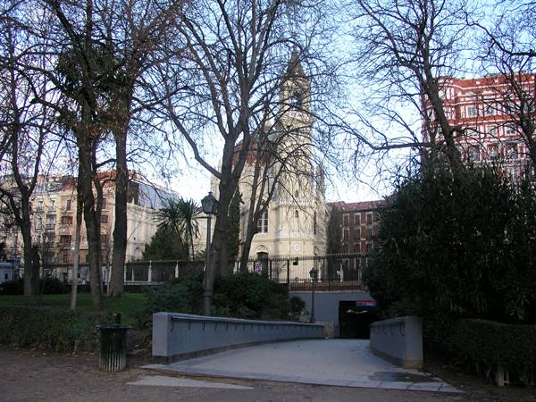 White church among bare trees, with concrete pedestrian underpass in the park